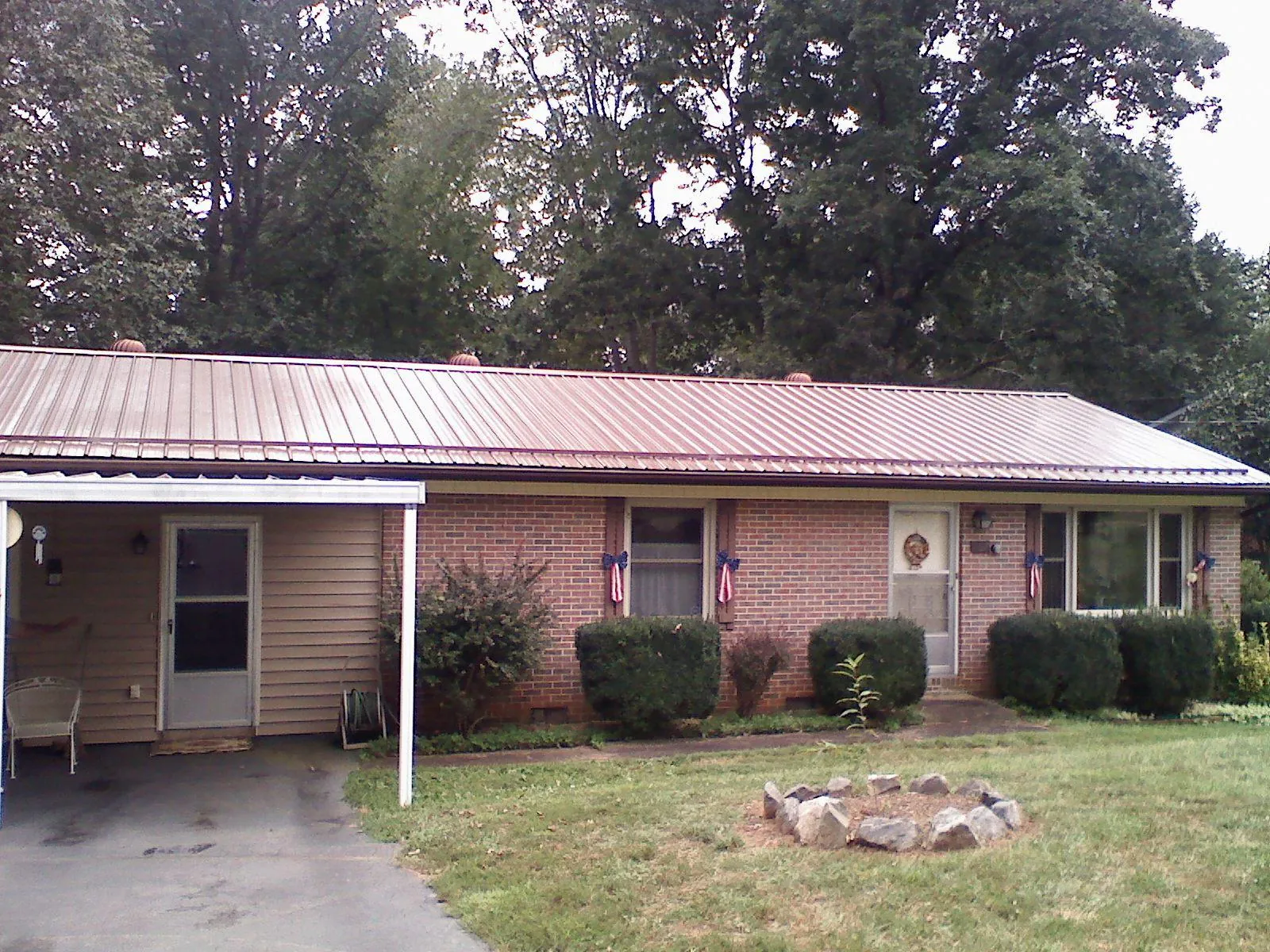 Bronze metal roof and carport on a brick ranch home — Roof Repair work by our crew in Lebanon